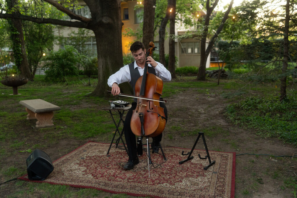 Professional cellist performing live music at an elegant event.
