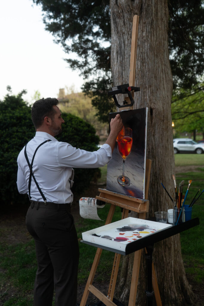 Artist creating a live painting at a special event, capturing the moment on canvas.